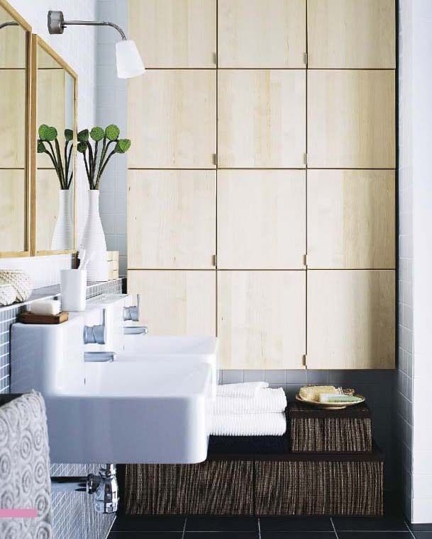 A bathroom with wood cabinets and a white double basin from the 2008 IKEA catalogue