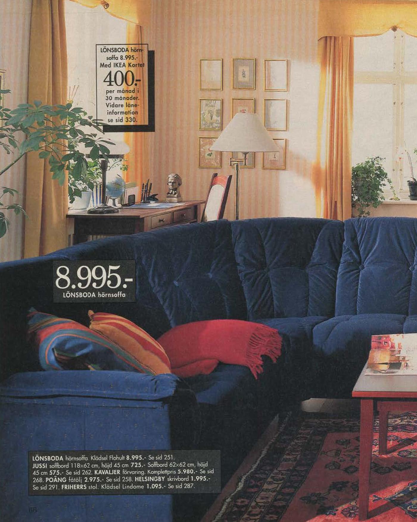 A catalogue image from 1996 showing a blue corner unit sofa with yellow curtains with swags at the top.