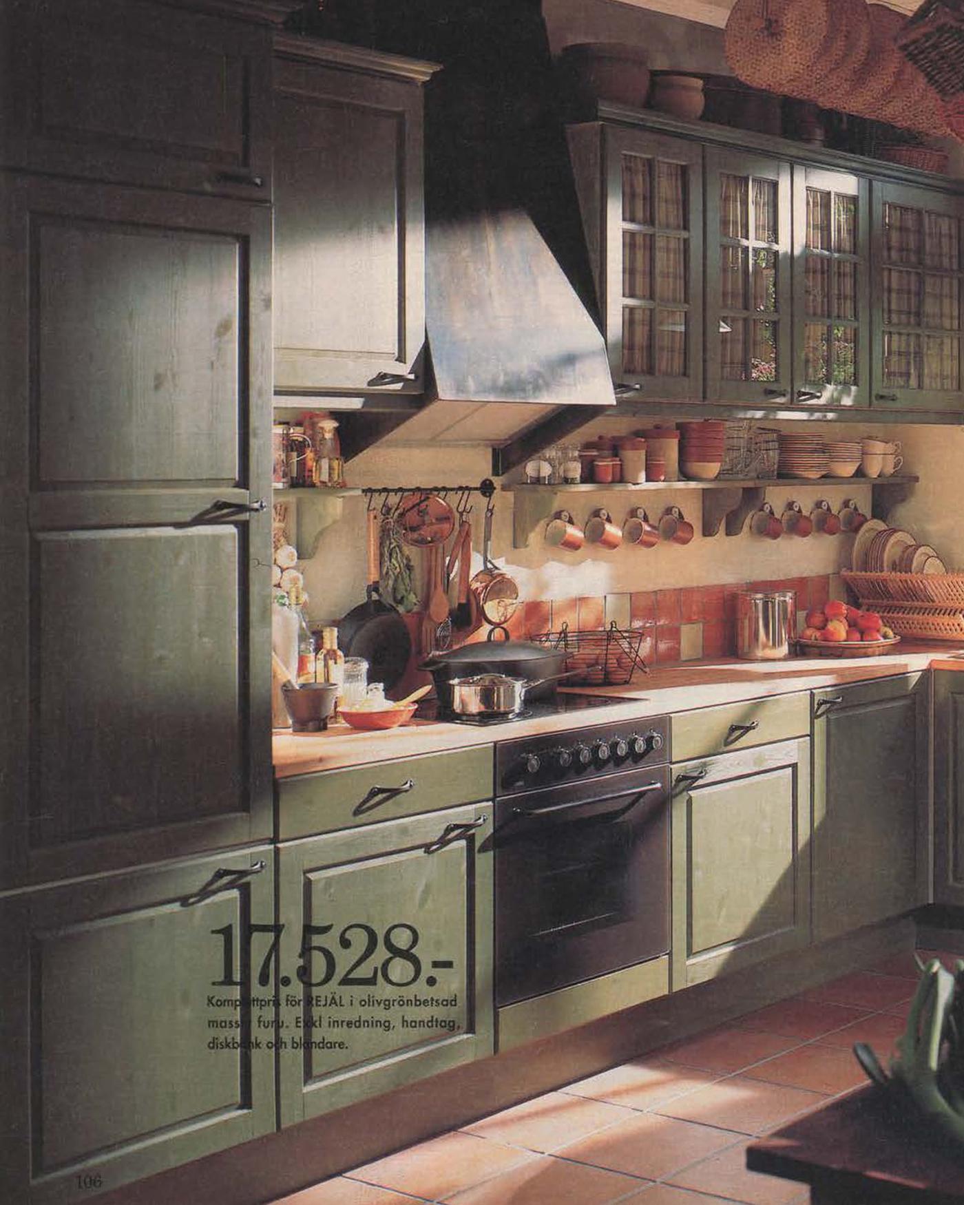 A green wood stained kitchen from the 1996 IKEA Catalogue, with hanging rails filled with cooking utensils.