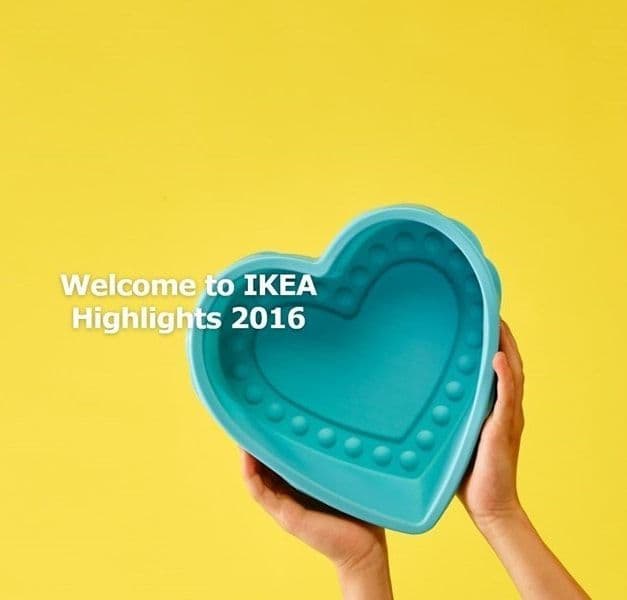Hands holding a green heart-shaped bowl against a yellow background.