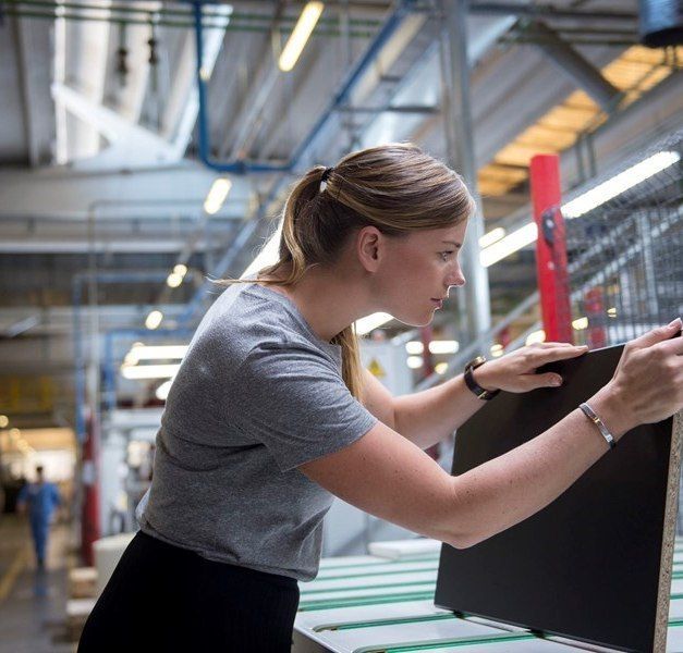 A woman examines a product.