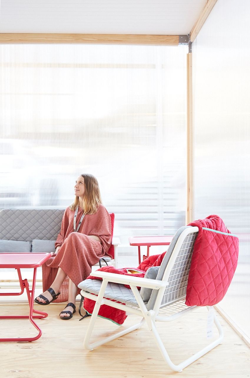 A woman sits on a chair.