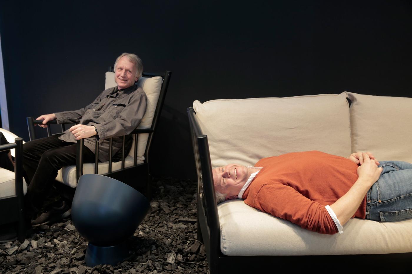 People sitting on furniture at an event.