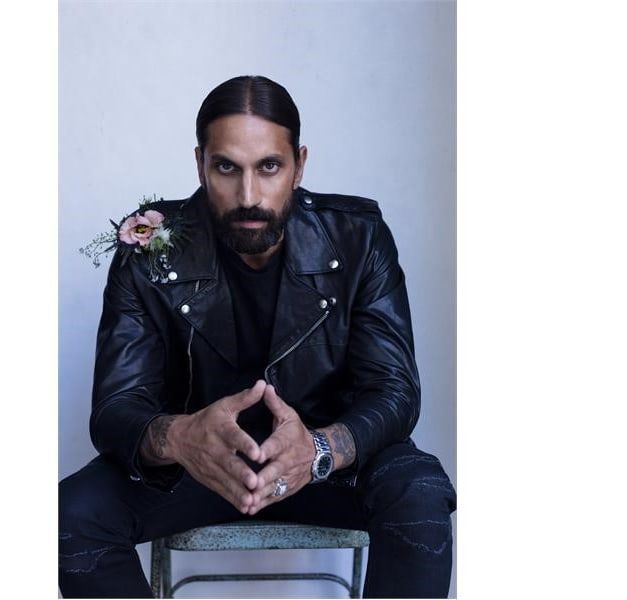 A seated man in a leather jacket.