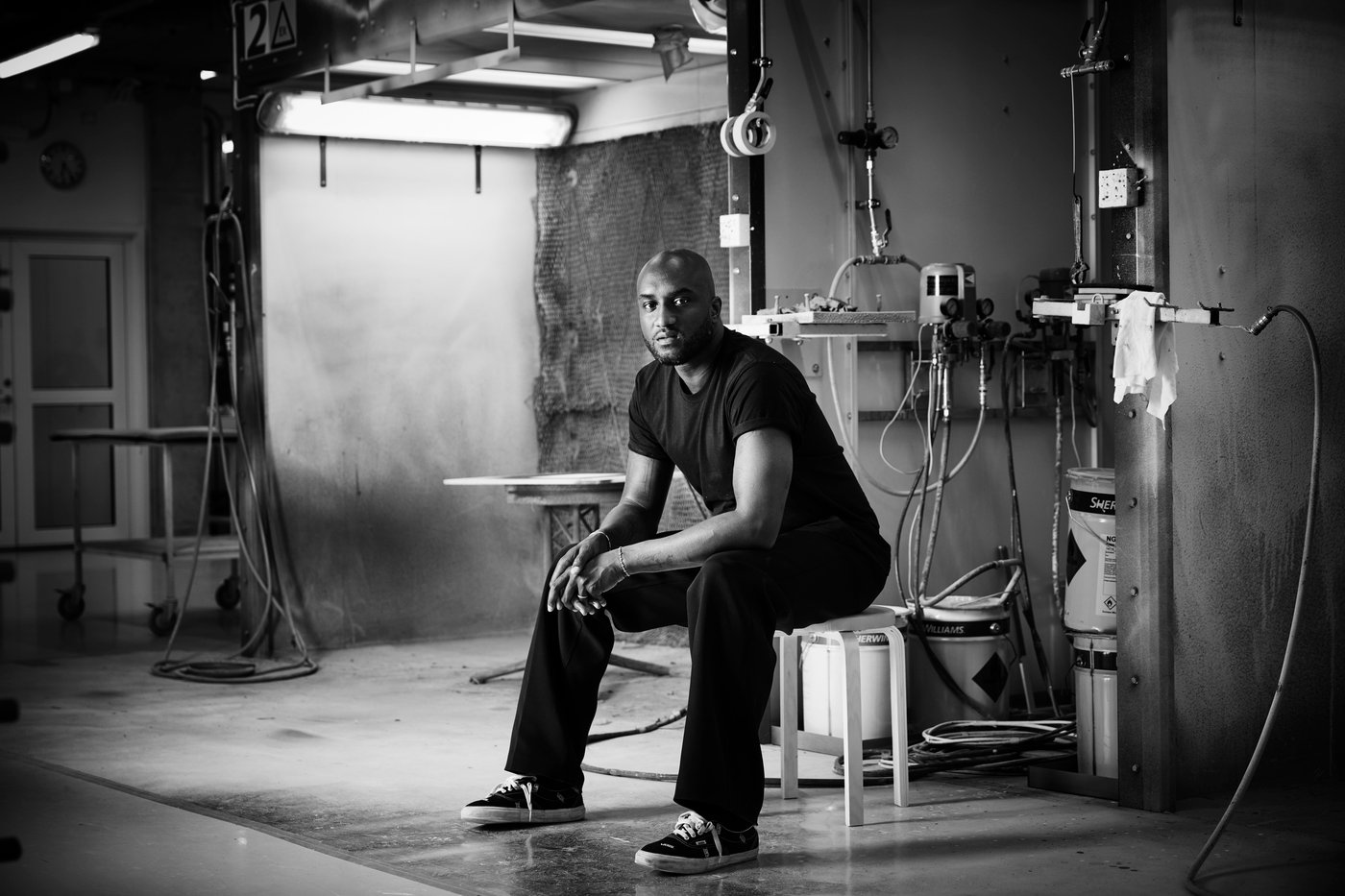 Virgil Abloh seated on a stool.
