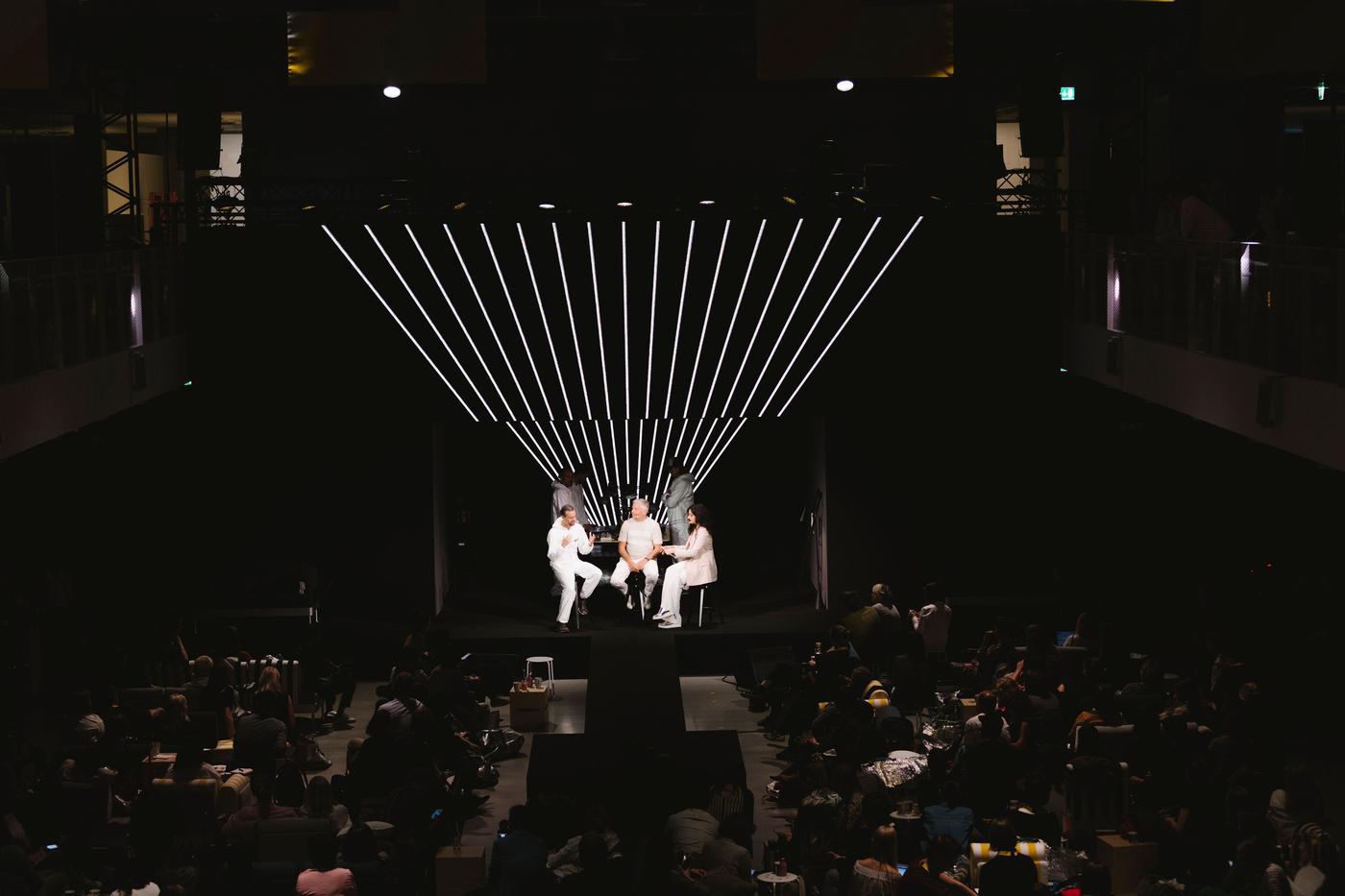 A group of three people on stage.