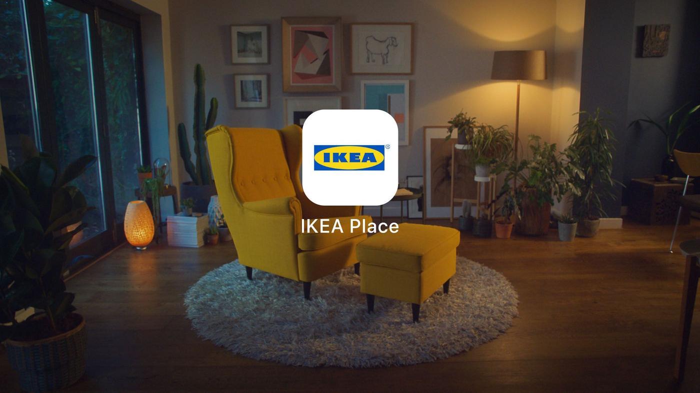 Photo of a living room with a yellow armchair and footrest in the centre on a round fluffy rug. IKEA Place app logo overlaid.