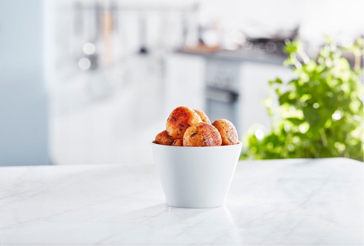 IKEA salmon balls in a white bowl in a white kitchen space.