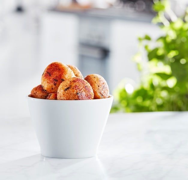 IKEA salmon balls in a white bowl in a white kitchen space.