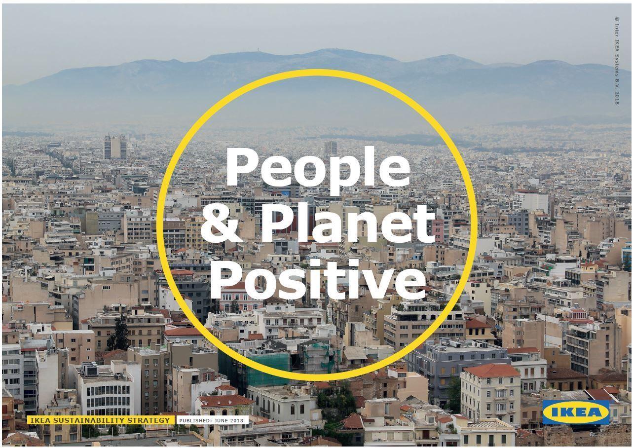 An aerial view of a city with a yellow circle and white text overlaid reading "People & Planet Positive"