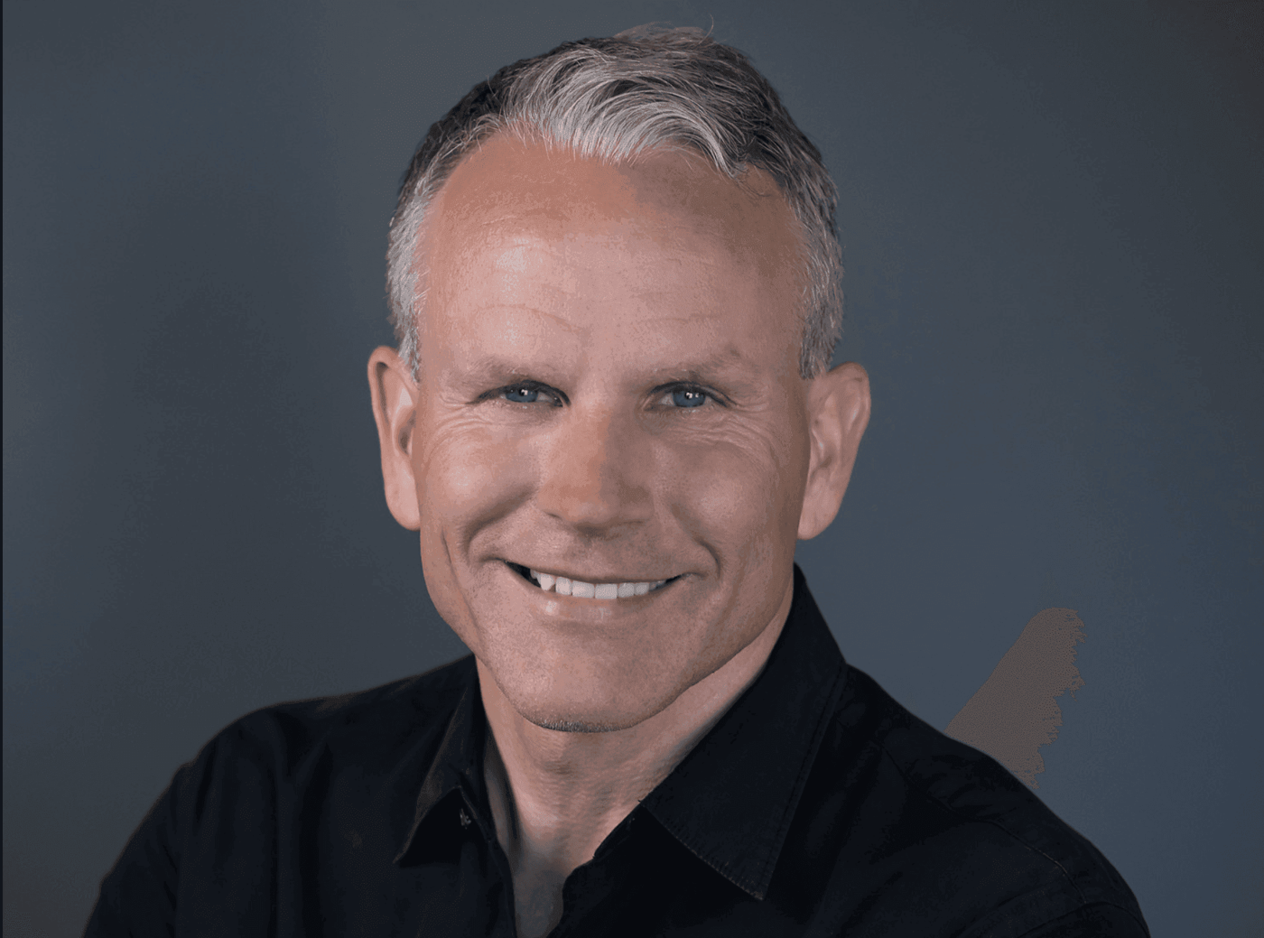 Portrait of Eythor Bender, smiling and wearing a black shirt.