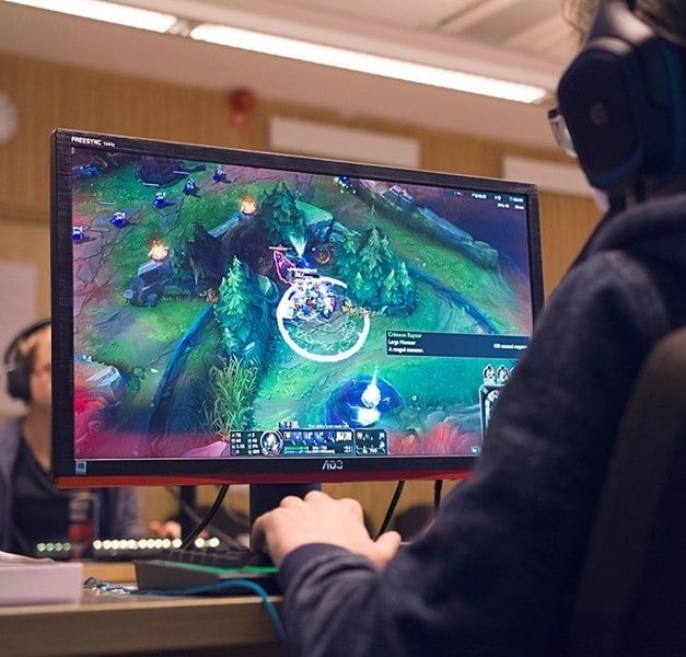 A person gaming at a desk.