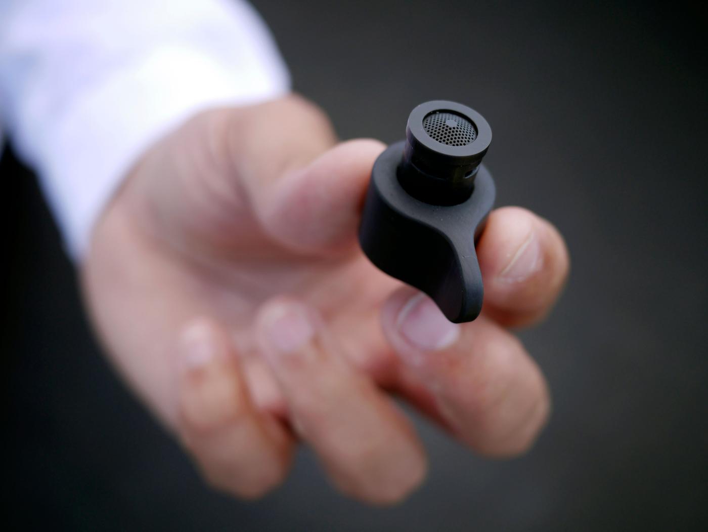 Hand holding a black MISTELN water nozzle.