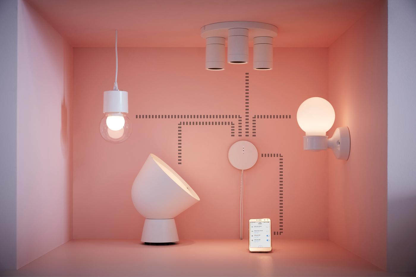 A small pink box with various light fixtures attached to the walls, floor and ceiling.