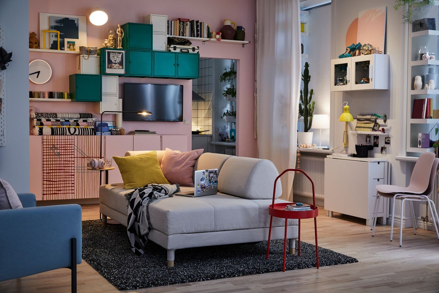 Pale pink living room with a red IKEA BURVIK side table.