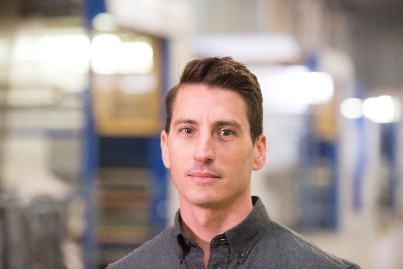 A man looks at the camer.