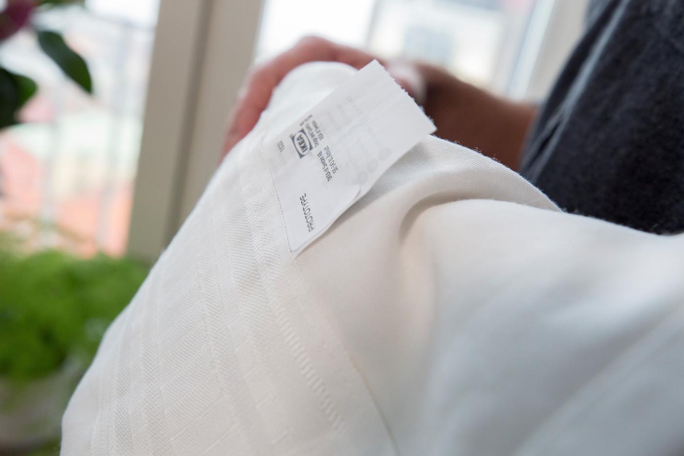 A person holds a GUNRID air purifying curtain in their arms.