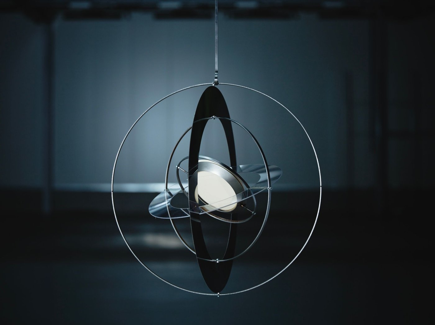Prototype of SAMMANLÄNKAD solar-powered pendant lamp in a dimly lit space.