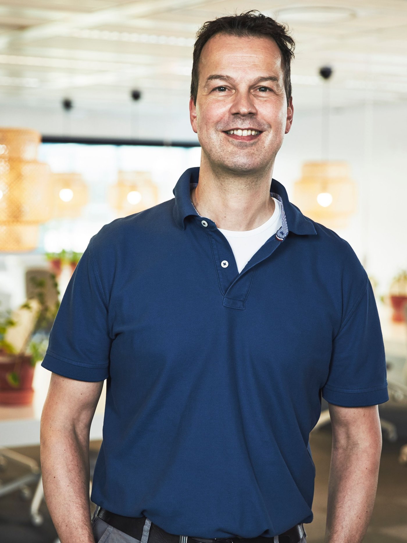 Portrait of Peter van der Poel wearing a blue shirt.