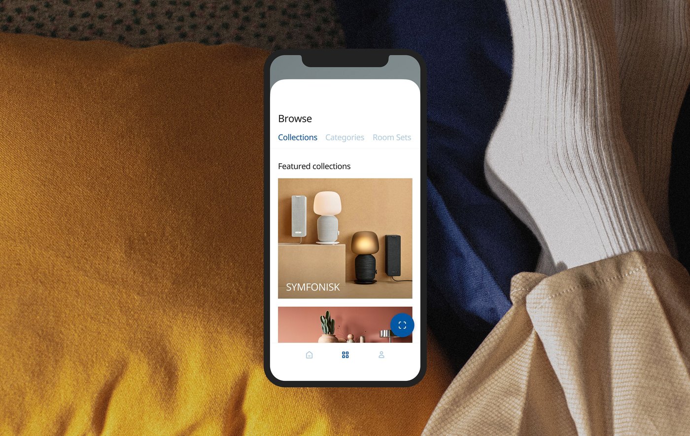 Visual of soft textiles with a person's feet wearing socks overlaid with a smartphone screen showing products from the SYMFONISK series.