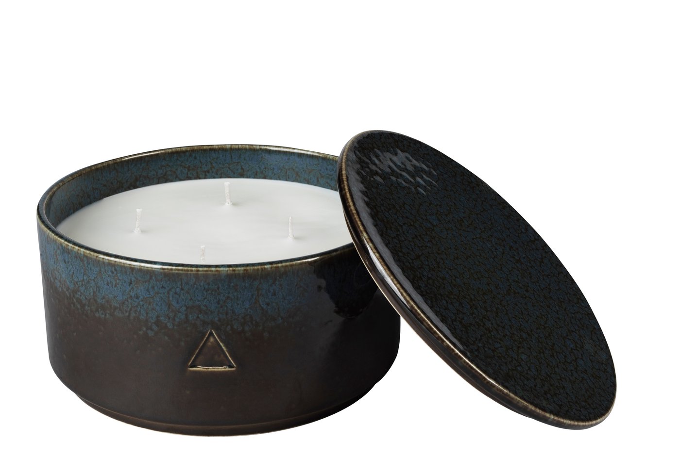 A dark brown and blue ceramic handle holder with a candle inside. Against a white background.
