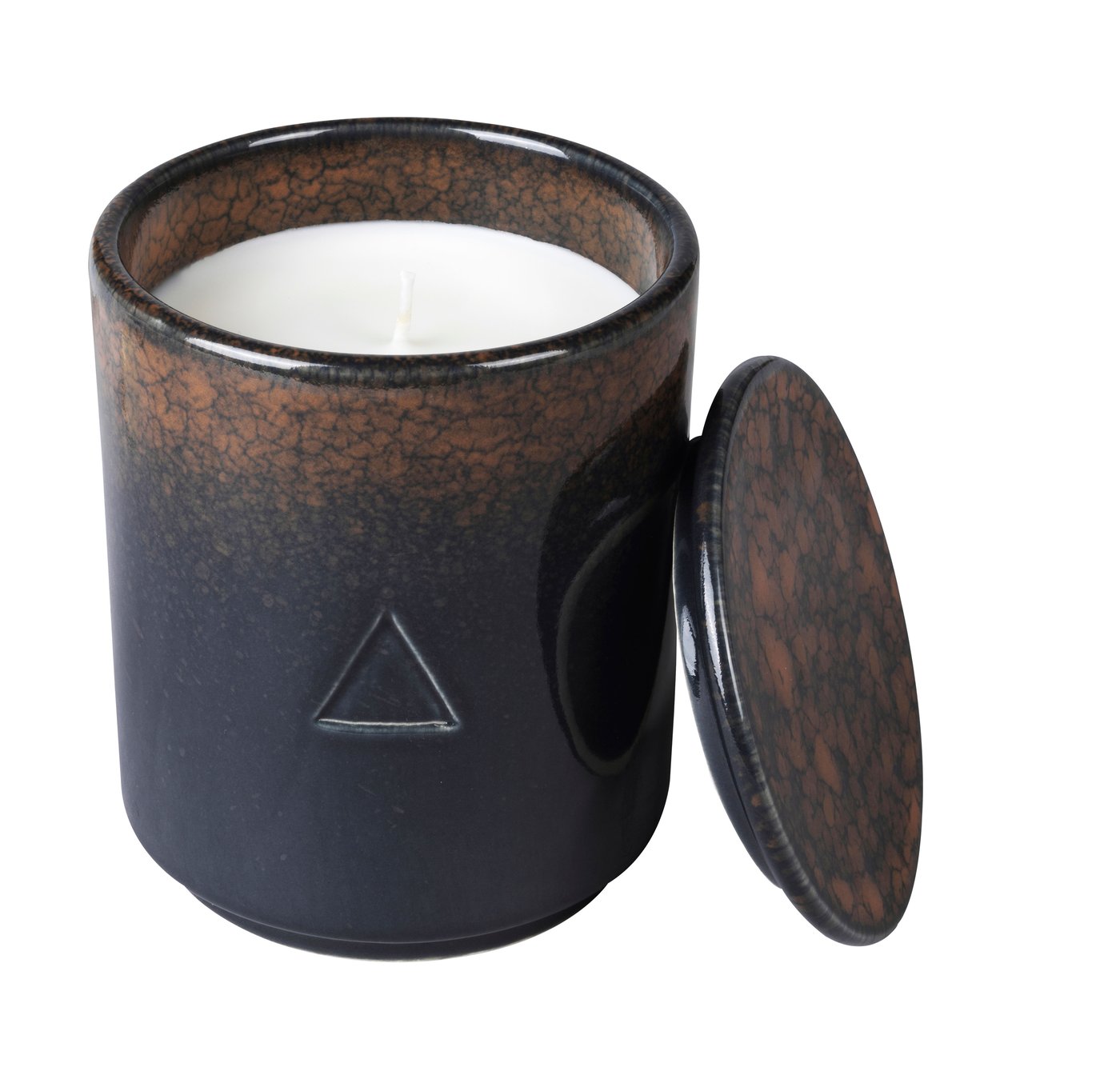 A dark brown ceramic handle holder with a candle inside and a lid leaning against it. Against a white background.