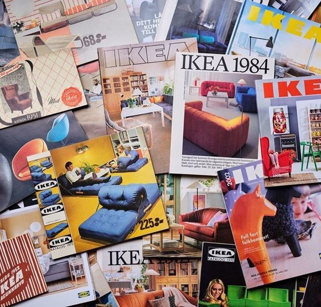 A collection of IKEA Catalogues are spread out on a flat surface.