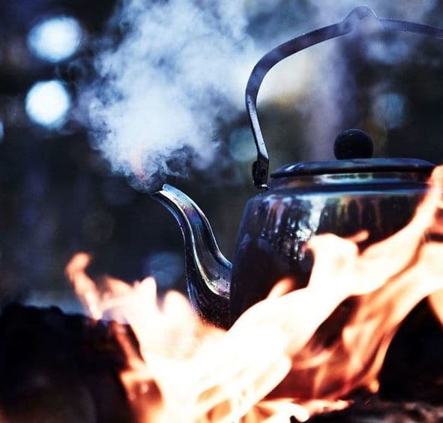 A kettle on an open flame.