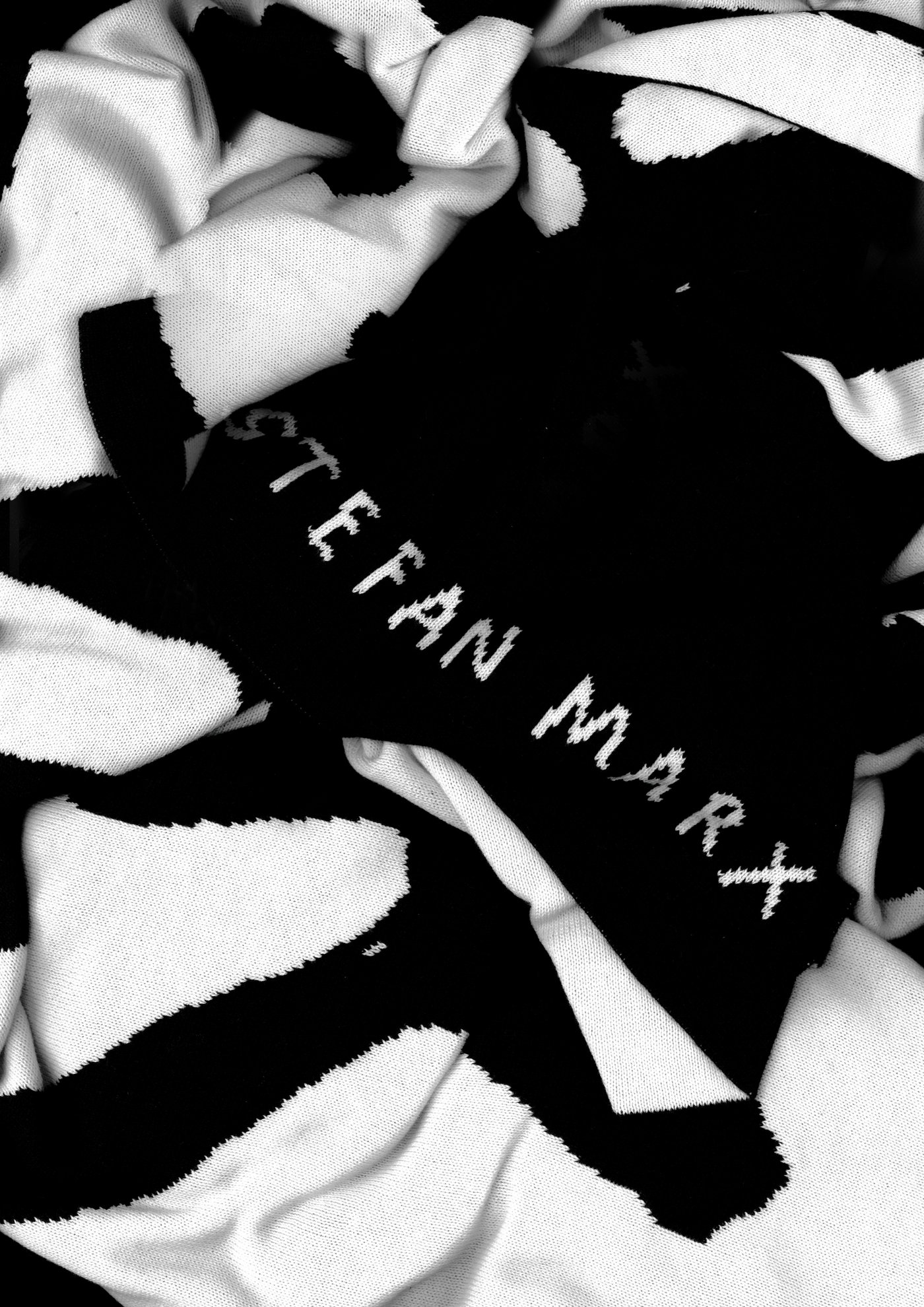 A closeup of a black and white graphic throw from the Art Event.