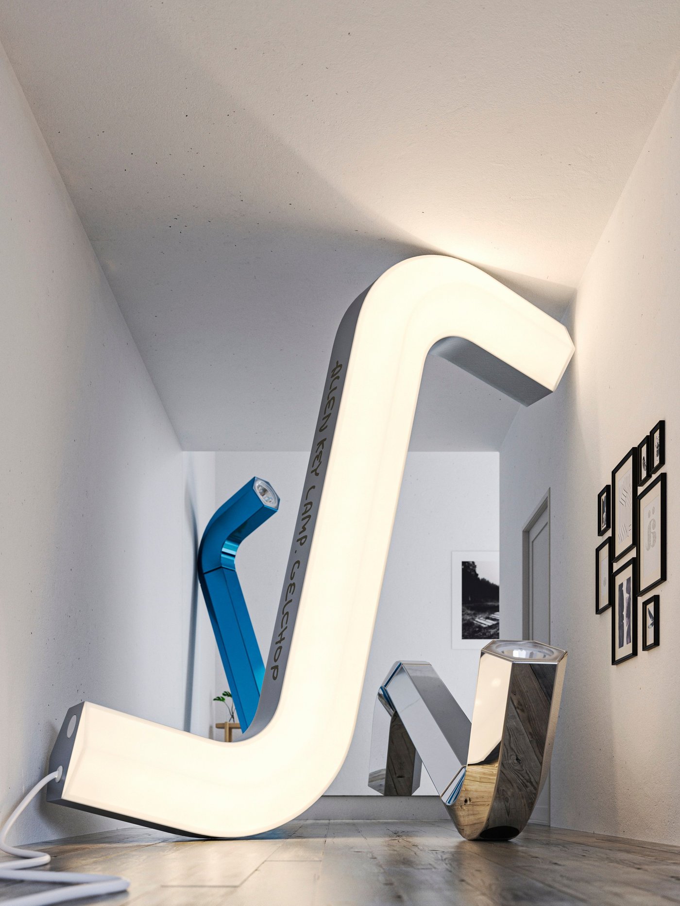 A large illuminated allen key leans against a wall. Behind are a silver and a blue allen key light leaning on the floor and wall.