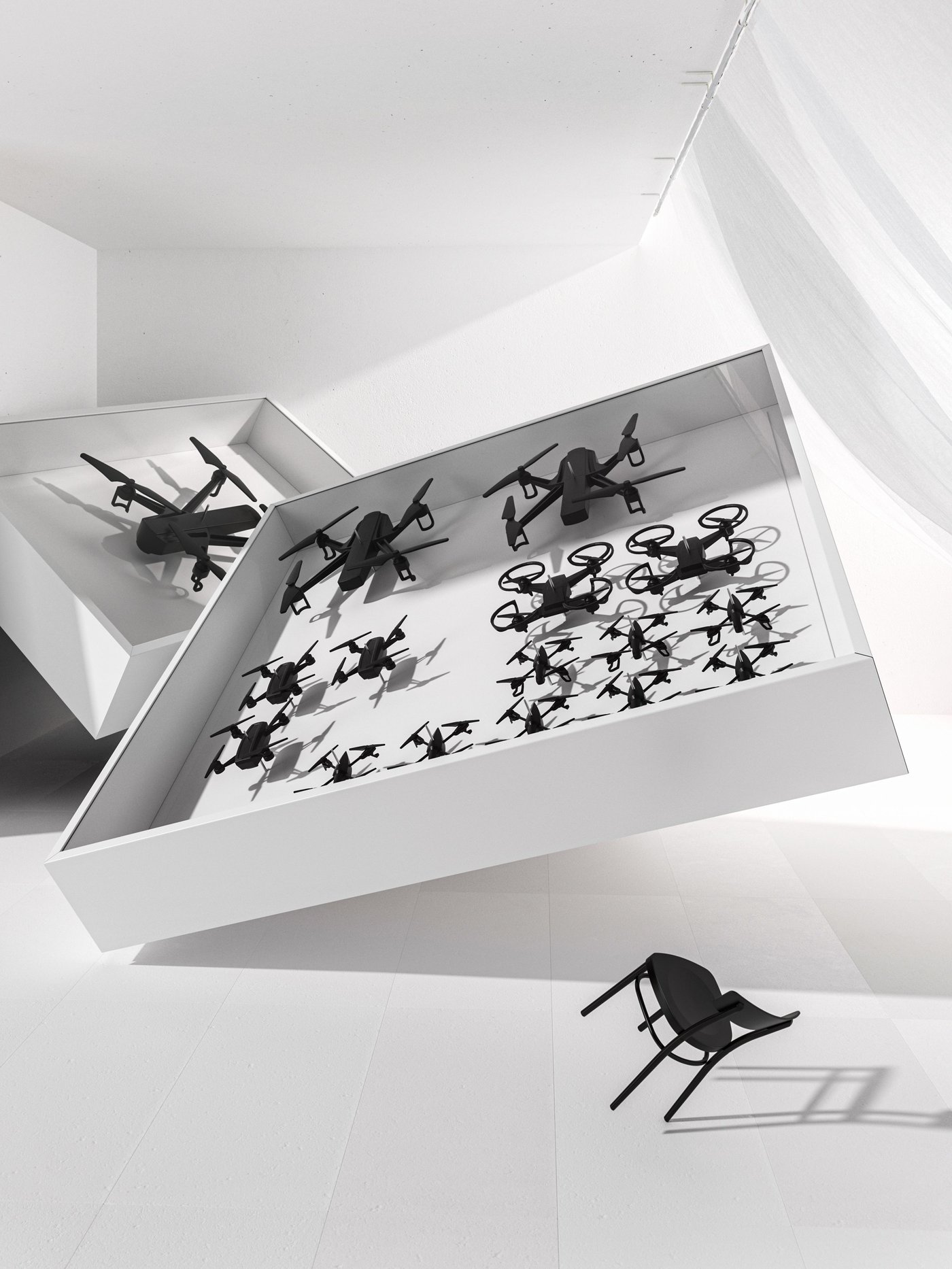 A collection of black drones in a white presentation frame with a small black chair.