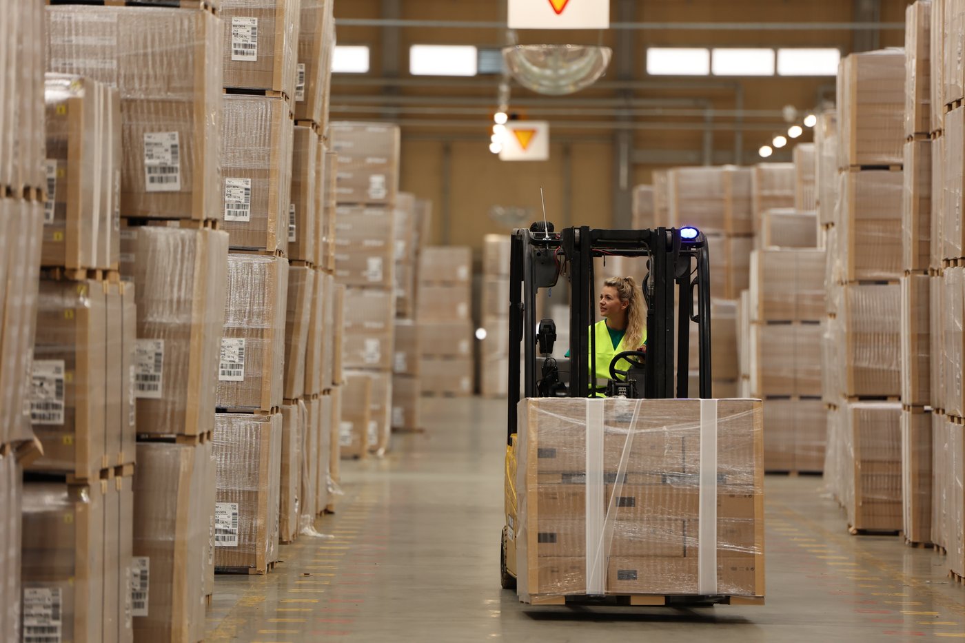 A person moving boxes using machinery in a factory in Zbaszynek.