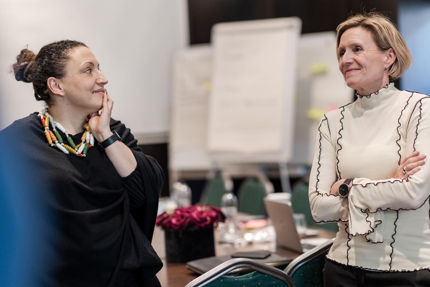 Two IKEA colleagues standing in an office space smiling