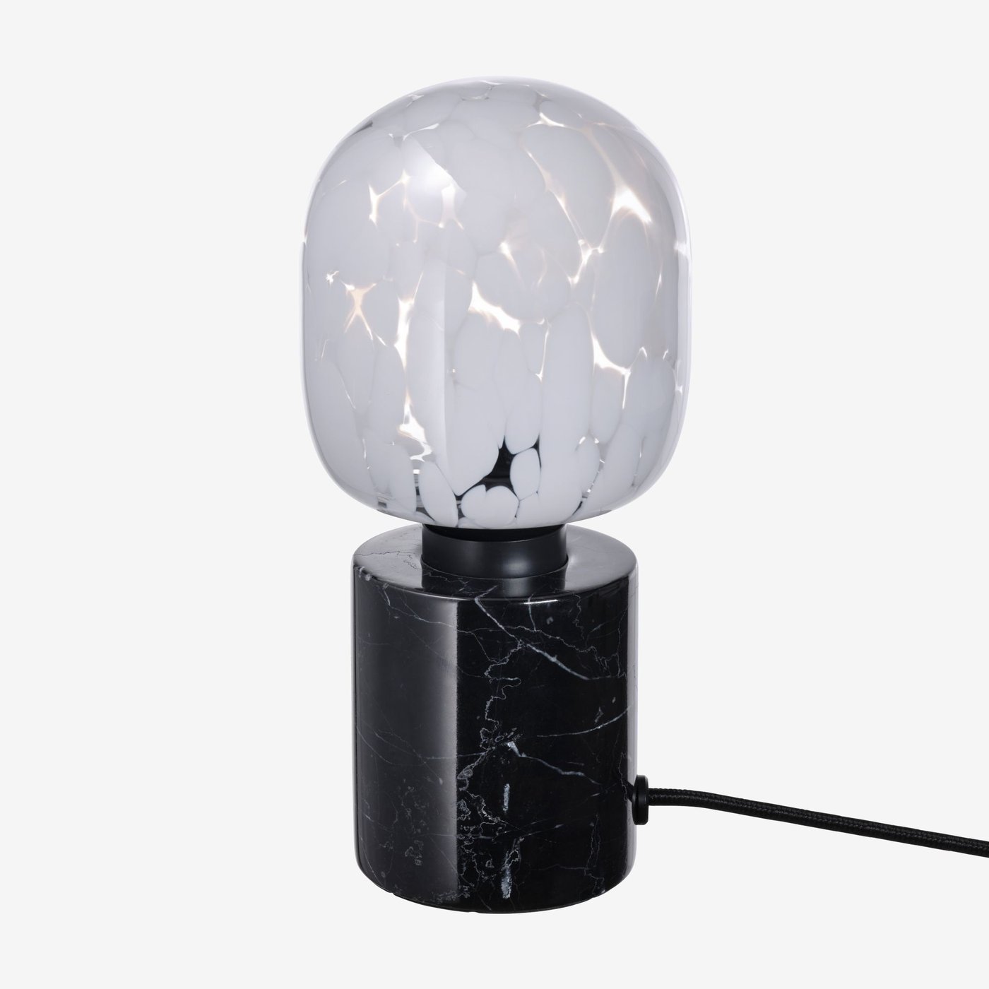 A patterned light bulb in a black circular lamp base.
