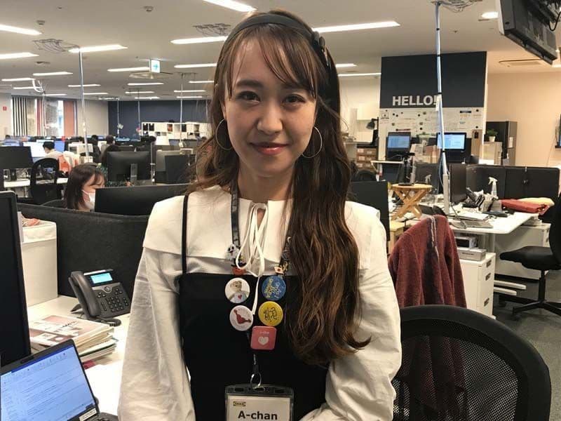 Aki a Japanese co-worker, smiles at the camera.