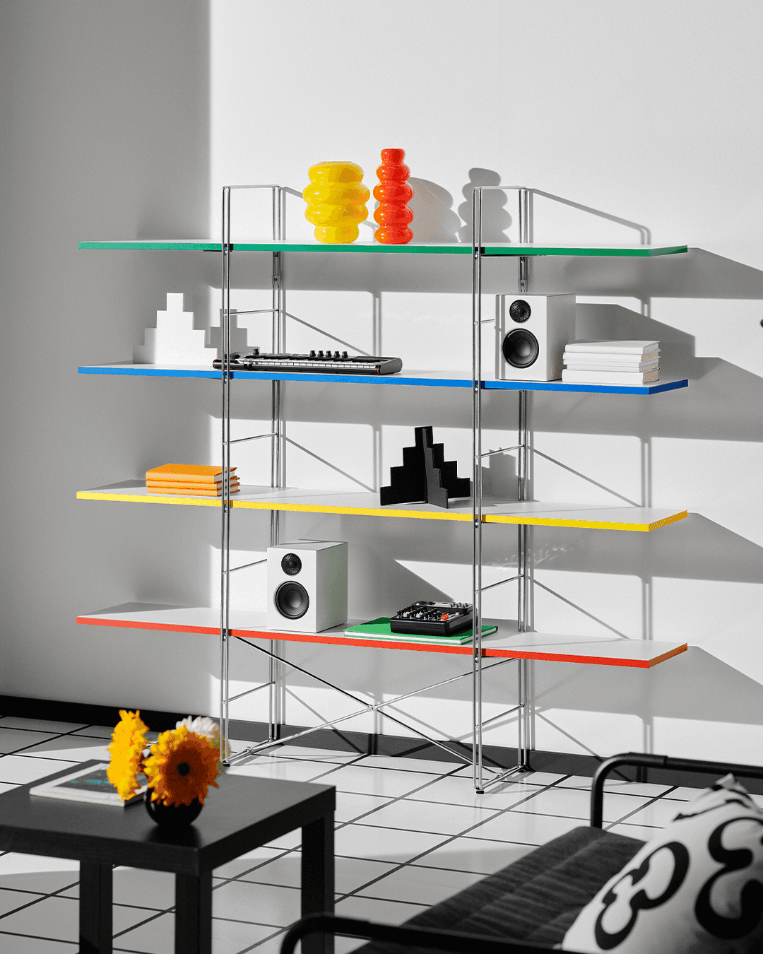 The BYAKORRE open shelving unit with a metal frame and coloured shelves, in a white roomset.