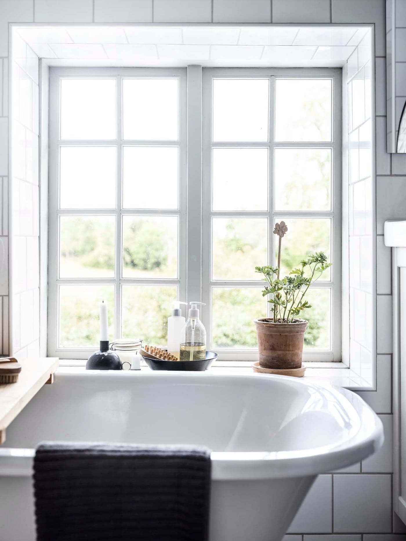 A bathtub beside a window,