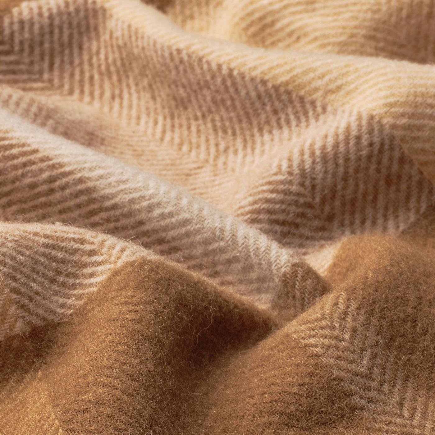 Close up of a brown, woollen MYRULL throw.
