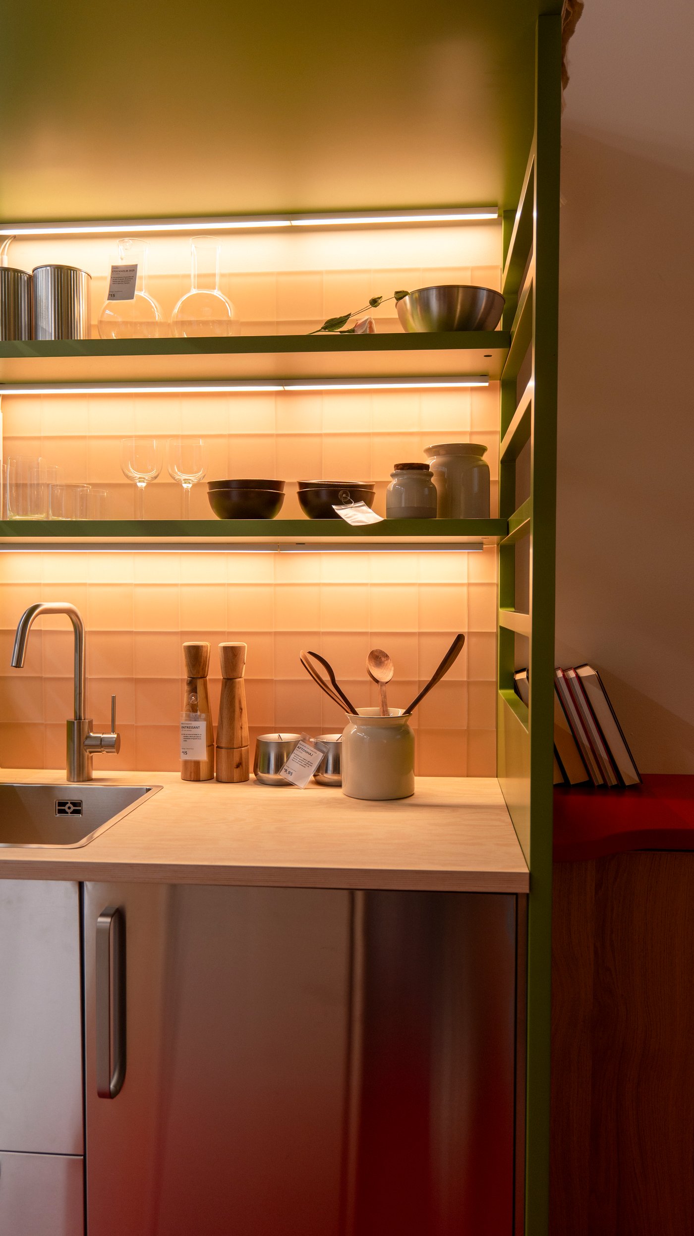 A kitchen sink with illuminated shelves.
