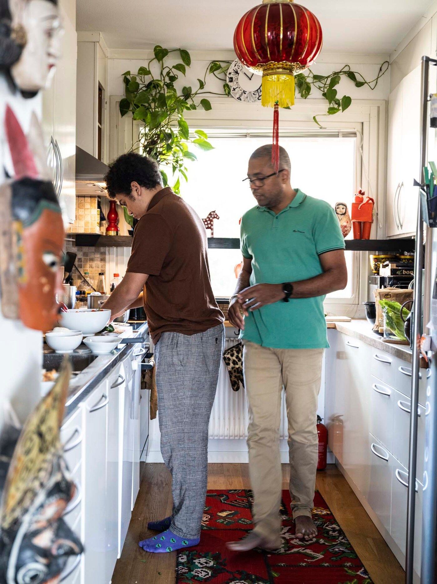 Cedric and Maxime preparing food in the kitchen.