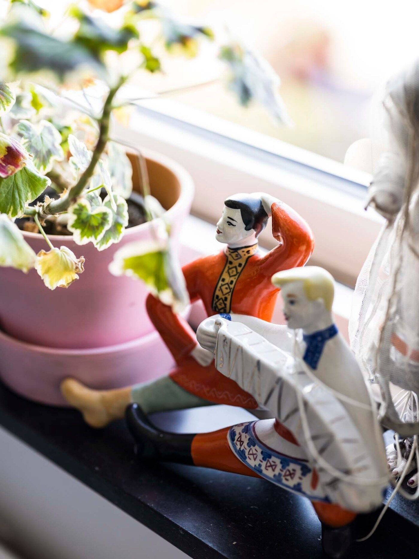 Small figures sit on a windowsill