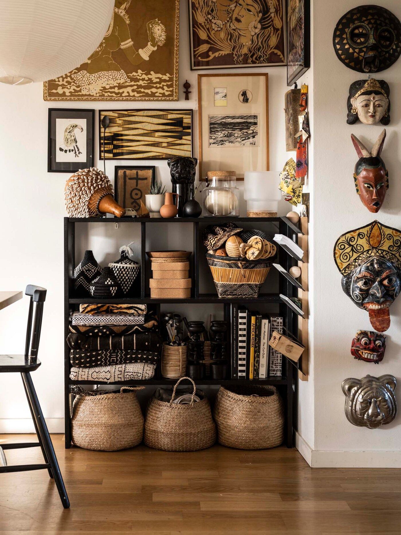Shelves with African souvenirs and masks on the wall.