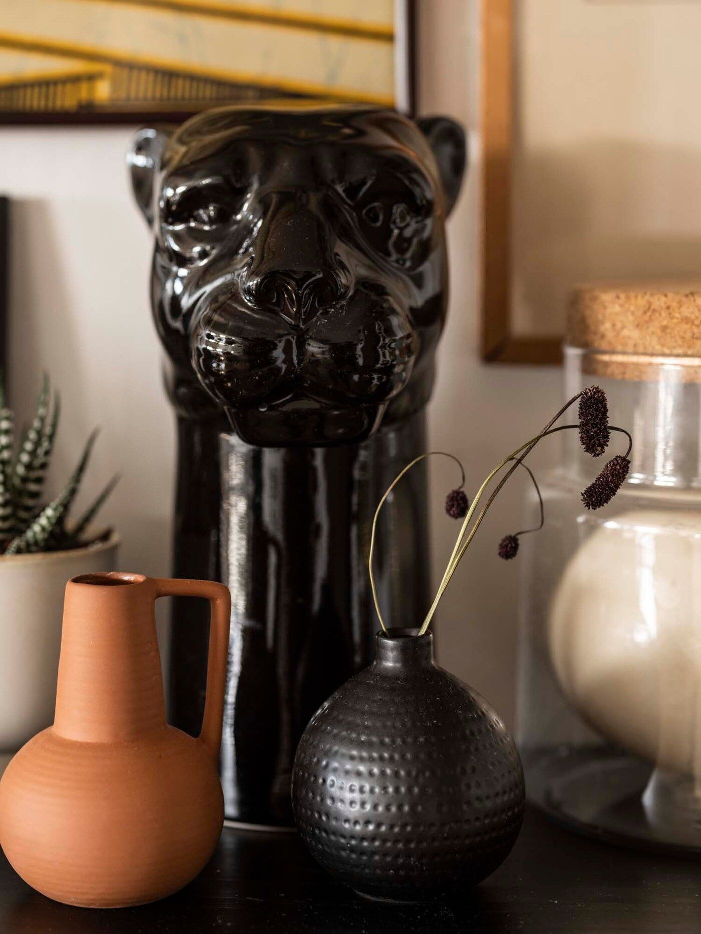 A black panther head sits on a shelf.