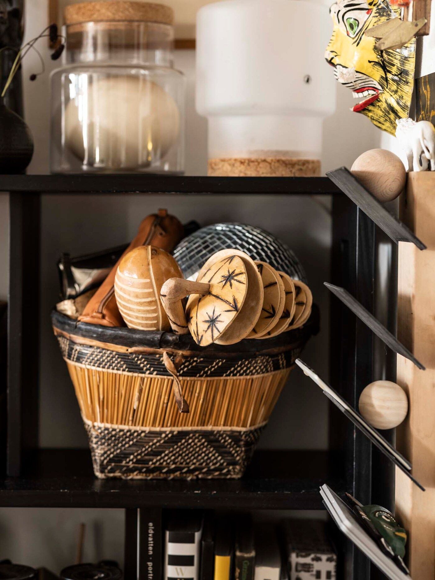 African souvenirs fill a basket on a shelf.