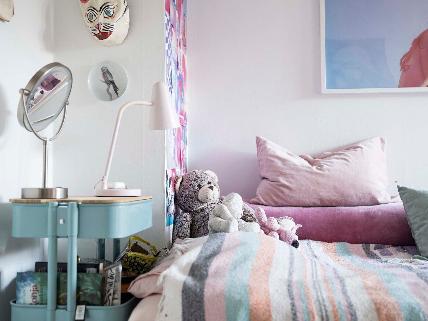 Blue trolley next to Anais' bed. There are soft toys on her bed and a bedside lamp.
