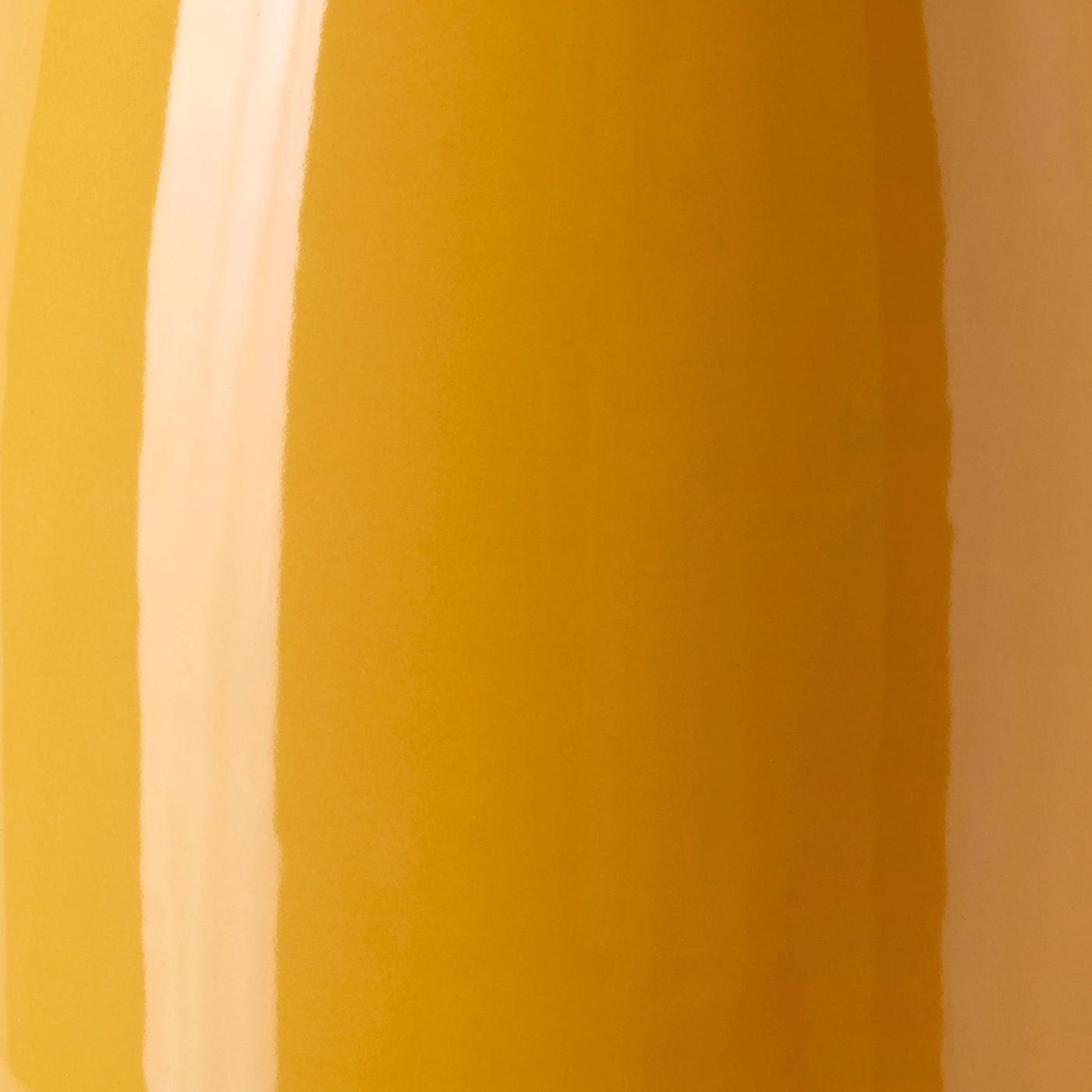 Close up of the shiny yellow ceramic surface of the KOPPARBJÖRK vase.