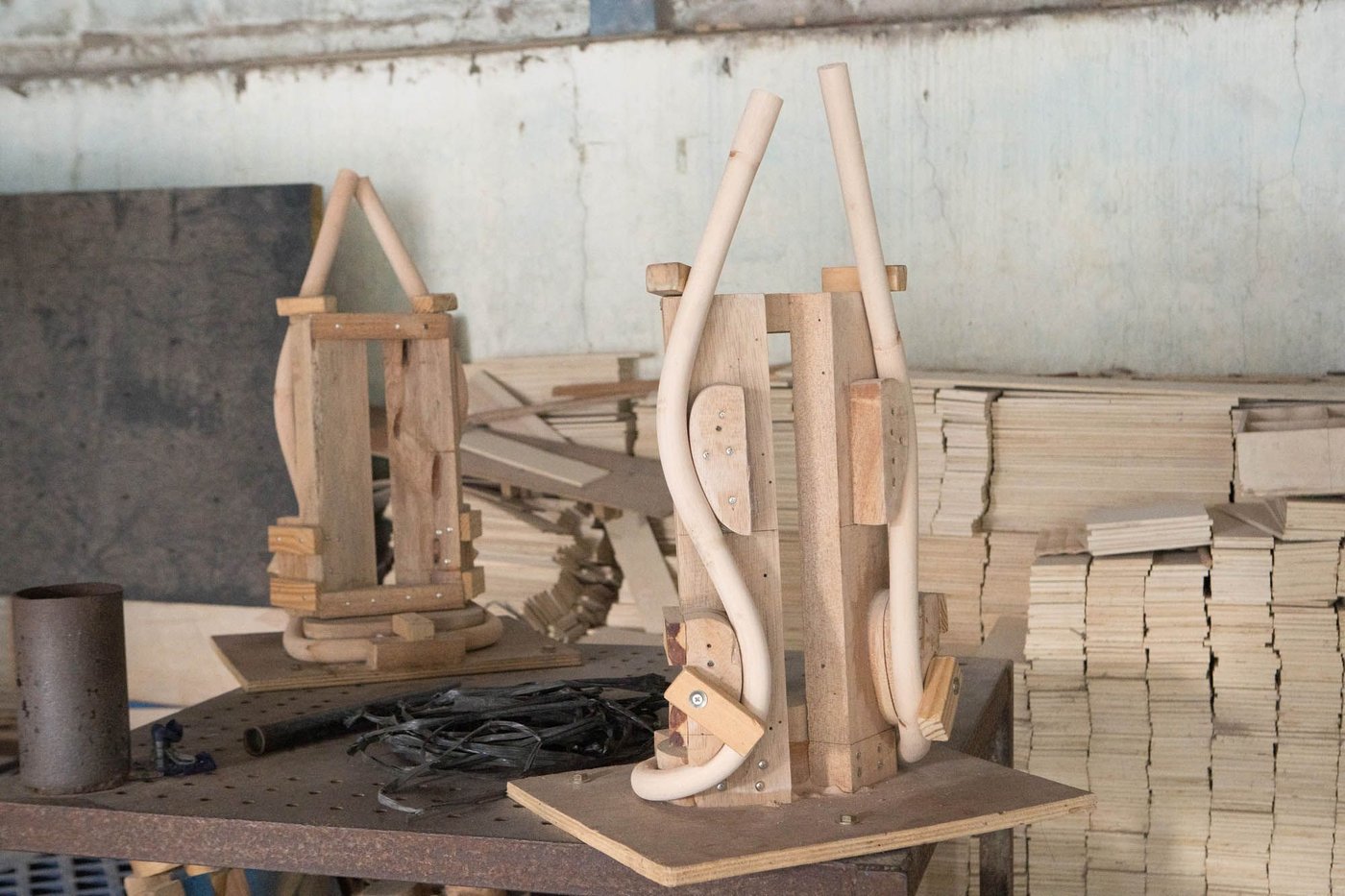 A room with rattan canes on a work surface being moulded into shape.