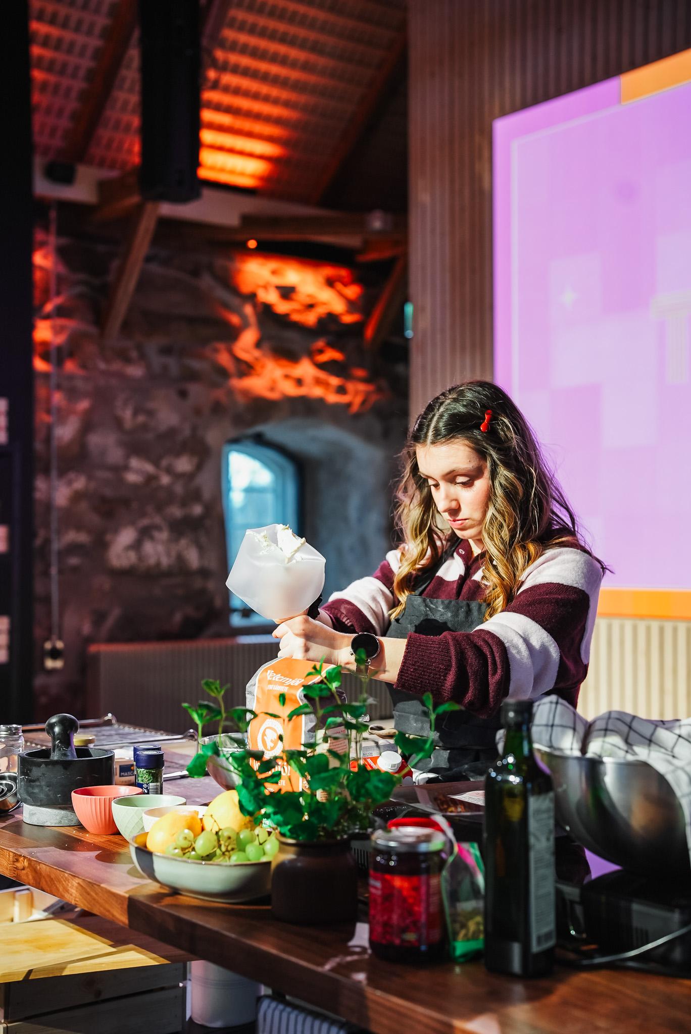A person in a cozy kitchen setting preparing food, surrounded by various ingredients and cooking tools.