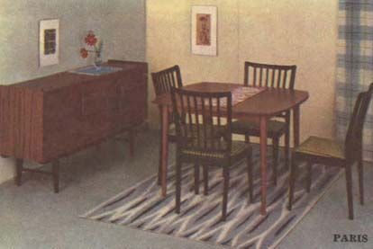 An image from the 1959 IKEA of a dining room with a dark wood sideboard unit. to the left and a table with four chairs on a rug.