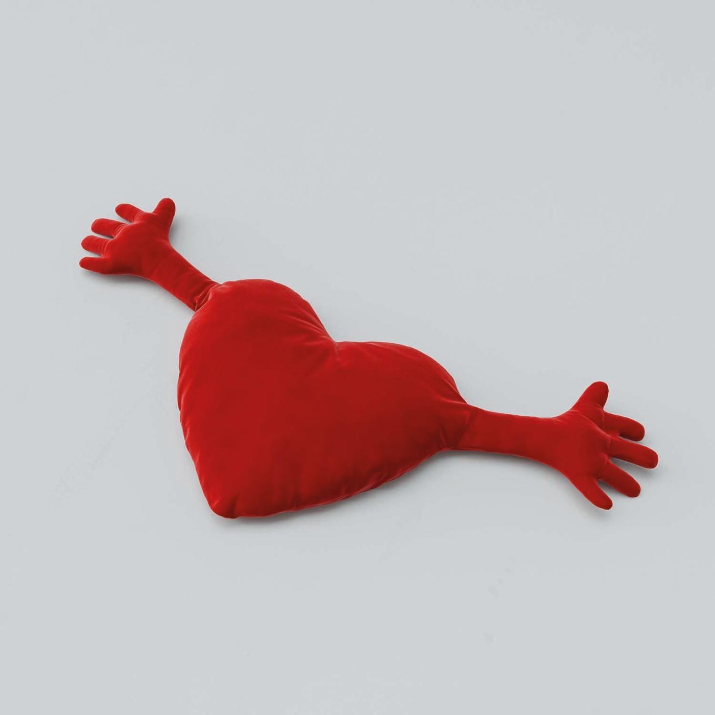 A red heart-shaped FAMNIG cushion.